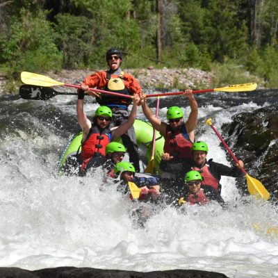 Group of people experiencing thrilling whitewater rafting in Aspen, Colorado.